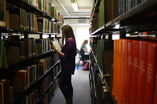 Photo of students in the stacks in Love Library