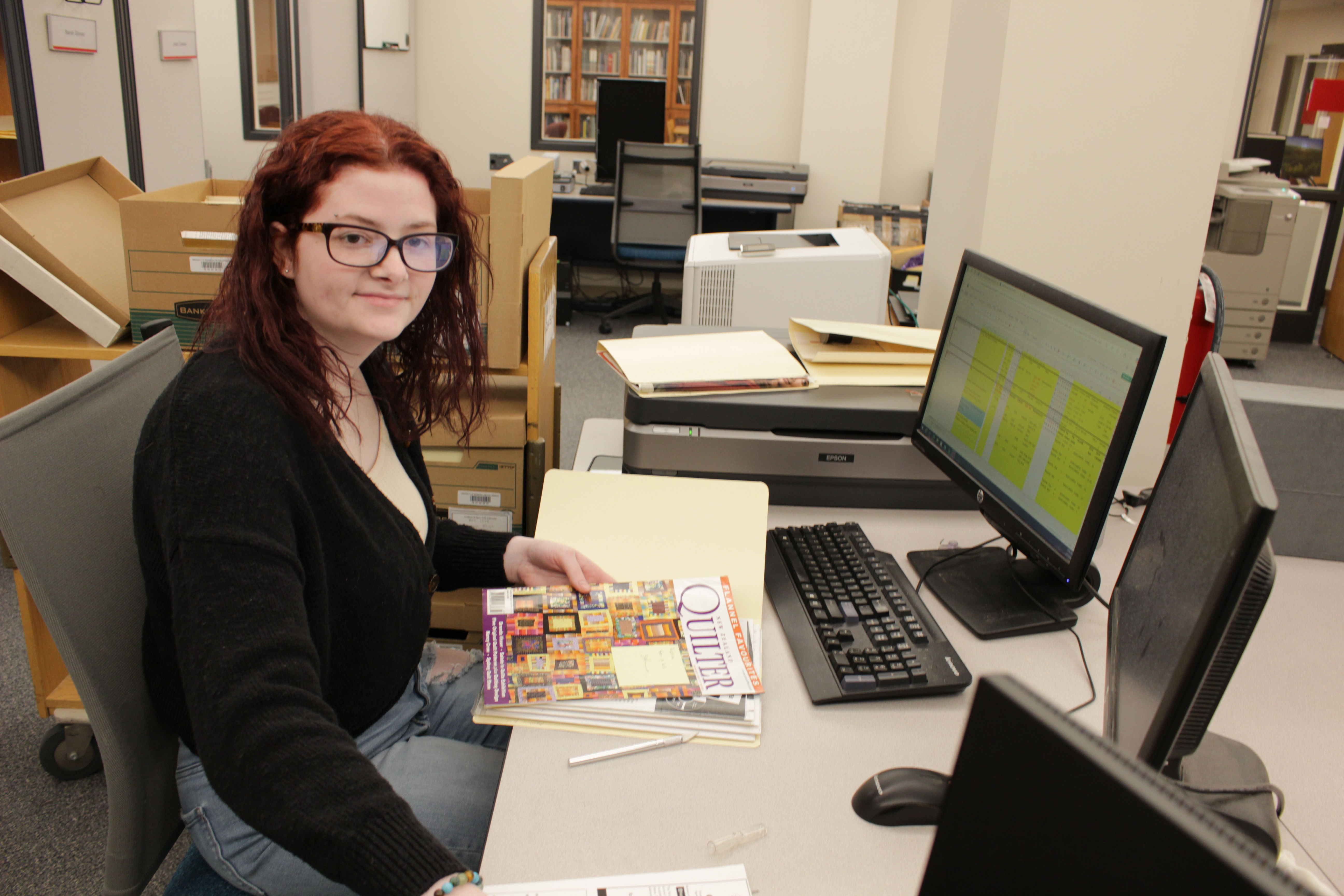 student working with quilt magazine