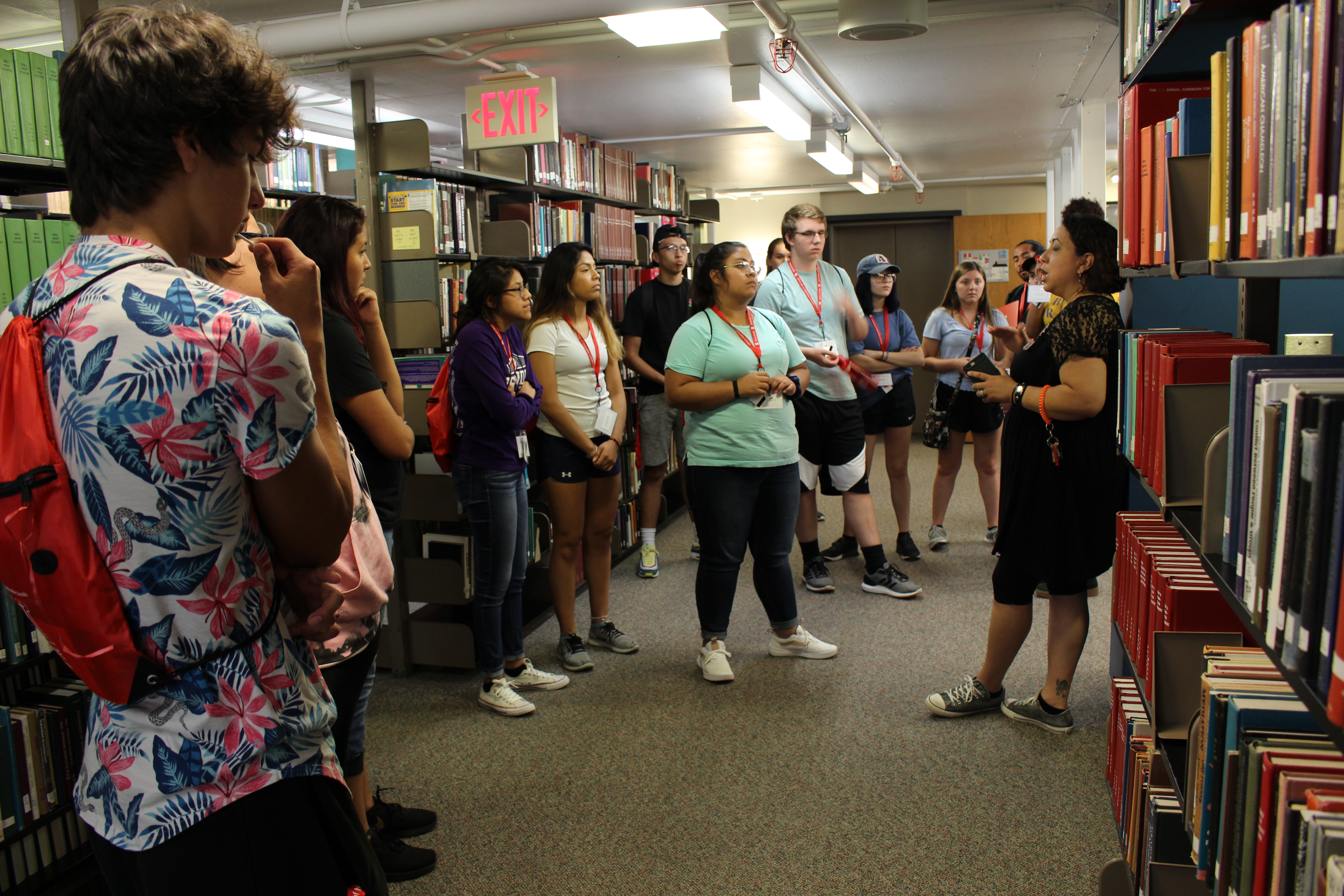 Photo of Librarian Toni Anaya leading a tour of students through the stacks 