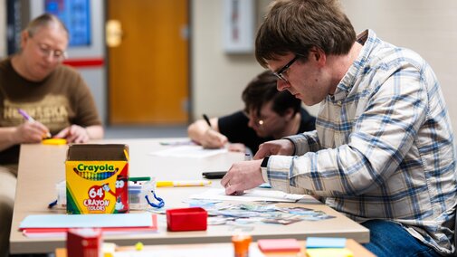 People creating mini art pages for the historical journal