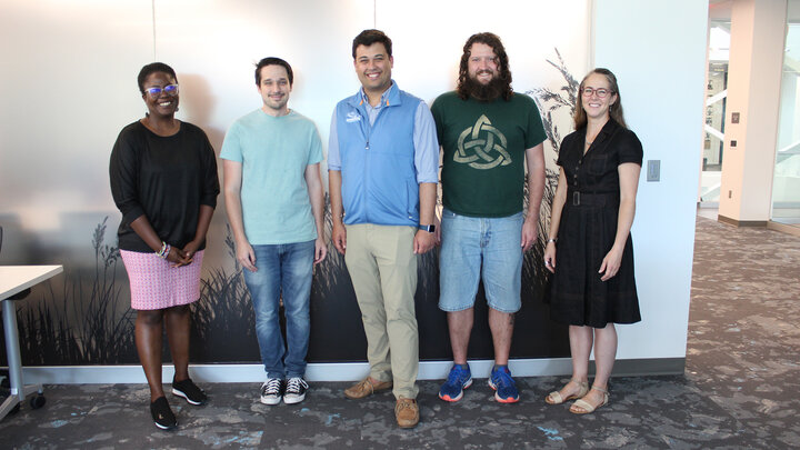 Carrie Heitman (right) stands with four program fellows.