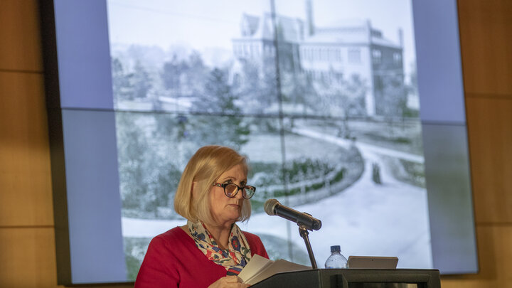 With an image of Architecture Hall — the university's first library — in the background, Kay Logan-Peters, professor of libraries, delivers an N150 Nebraska Lecture at the Champion’s Club on Feb. 12. Nearly 300 attended the event, which featured a historic tour of campus architecture, spanning the university’s first building to the roots of the modern-day campus.