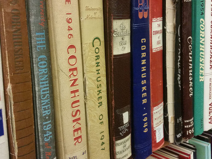 Yearbooks on a book shelf.