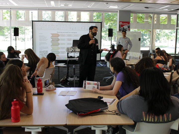 Librarian presenting to students sitting at tables