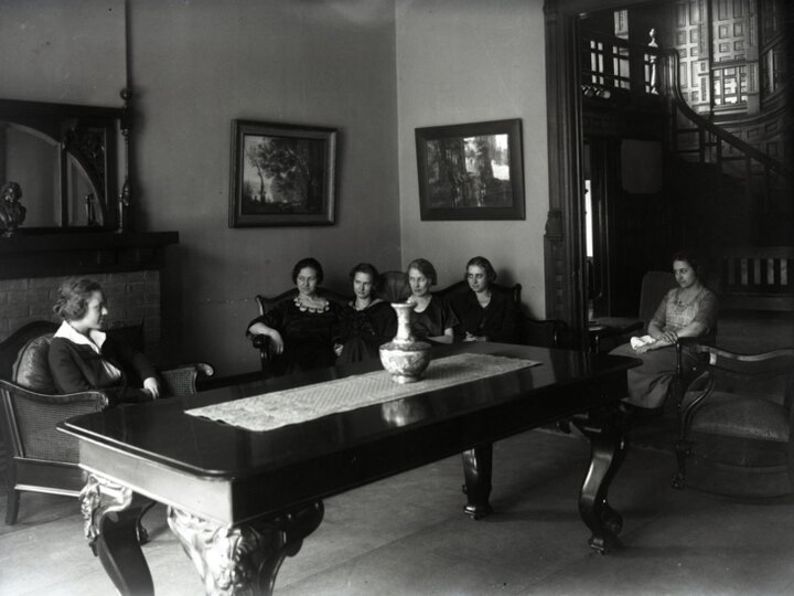 Photo from archives of women sitting around a large table