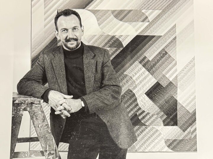 Michael James in front of artwork