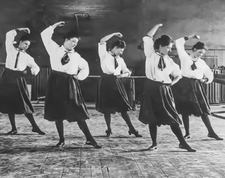 Historical photo of women dancing as part of Women's in Athletics exhibit