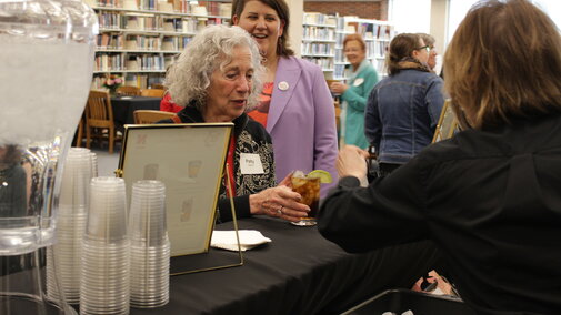 Server giving a mocktail drink to an event attendee