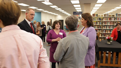 Dean Lorang talking with 3-4 other people