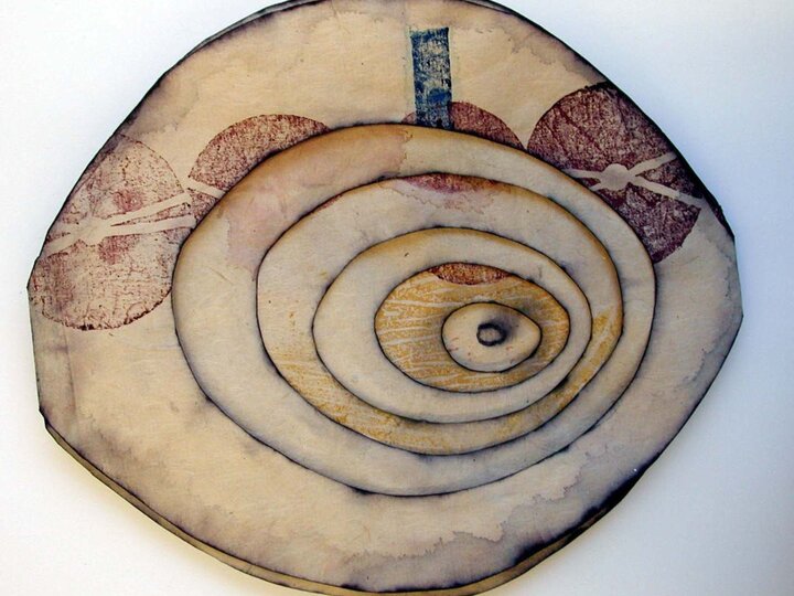 Watercolor woodcut on handmade kozo paper. Eye-shaped pages hinged and folded accordion style. The interior of each page is cut out in successively smaller ovals, each colored and edged in black.