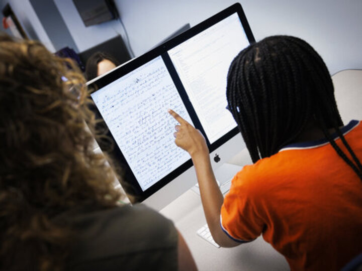 student pointing to a document displaying on the screen